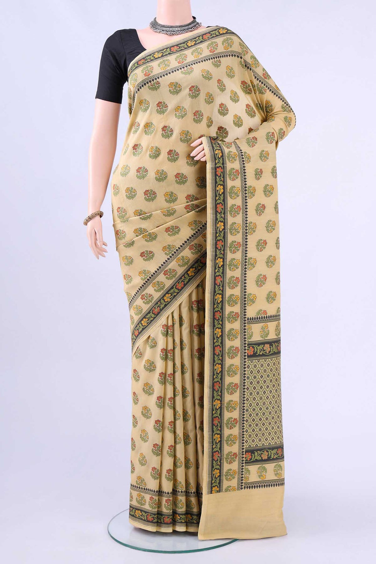 Cream Banarasi Saree with Thread Butta on the body and Thread Border displayed on a mannequin