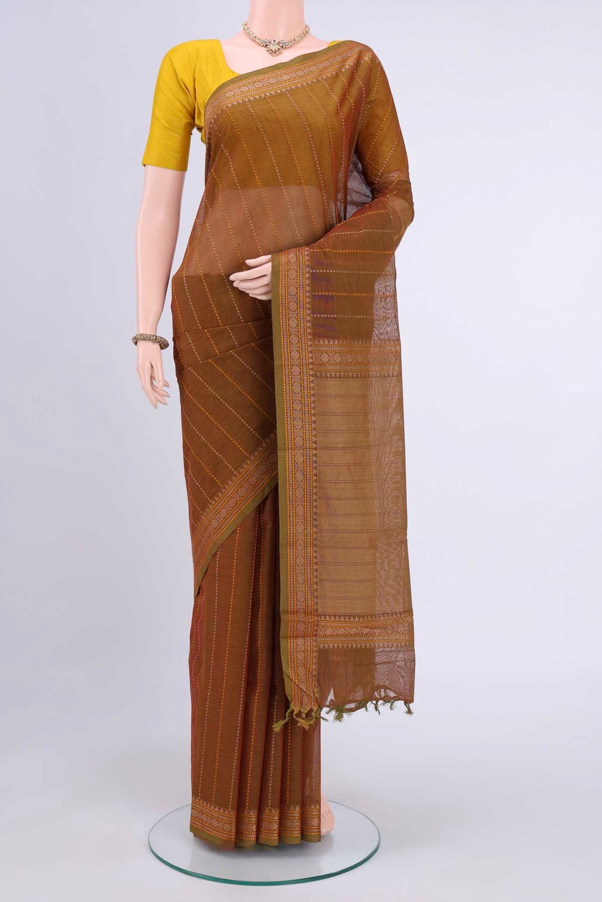 Mustard Kanchi Cotton Saree with Stripes on the body and Plain Border displayed on a mannequin