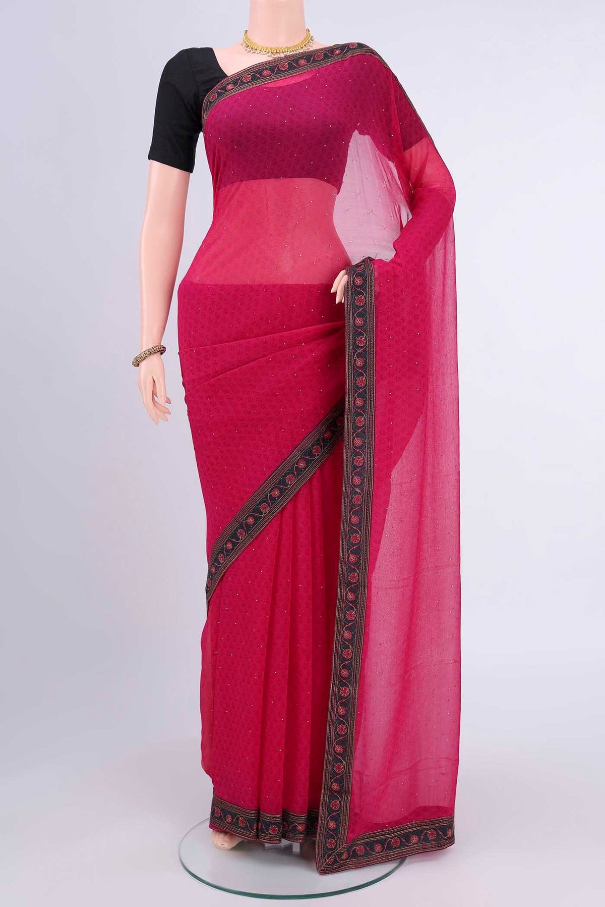 Dark Pink Chiffon Saree with Printed design on the body and Attached Border displayed on a mannequin