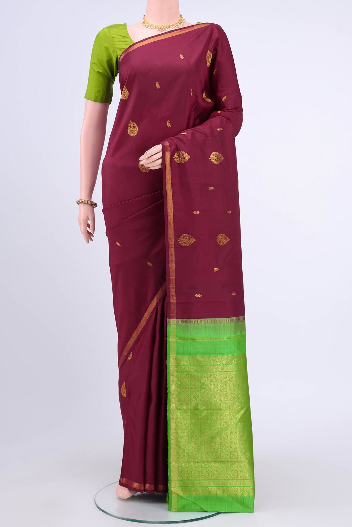 Maroon Kanchipuram Saree with Zari Butta on the body and Zari Border displayed on a mannequin
