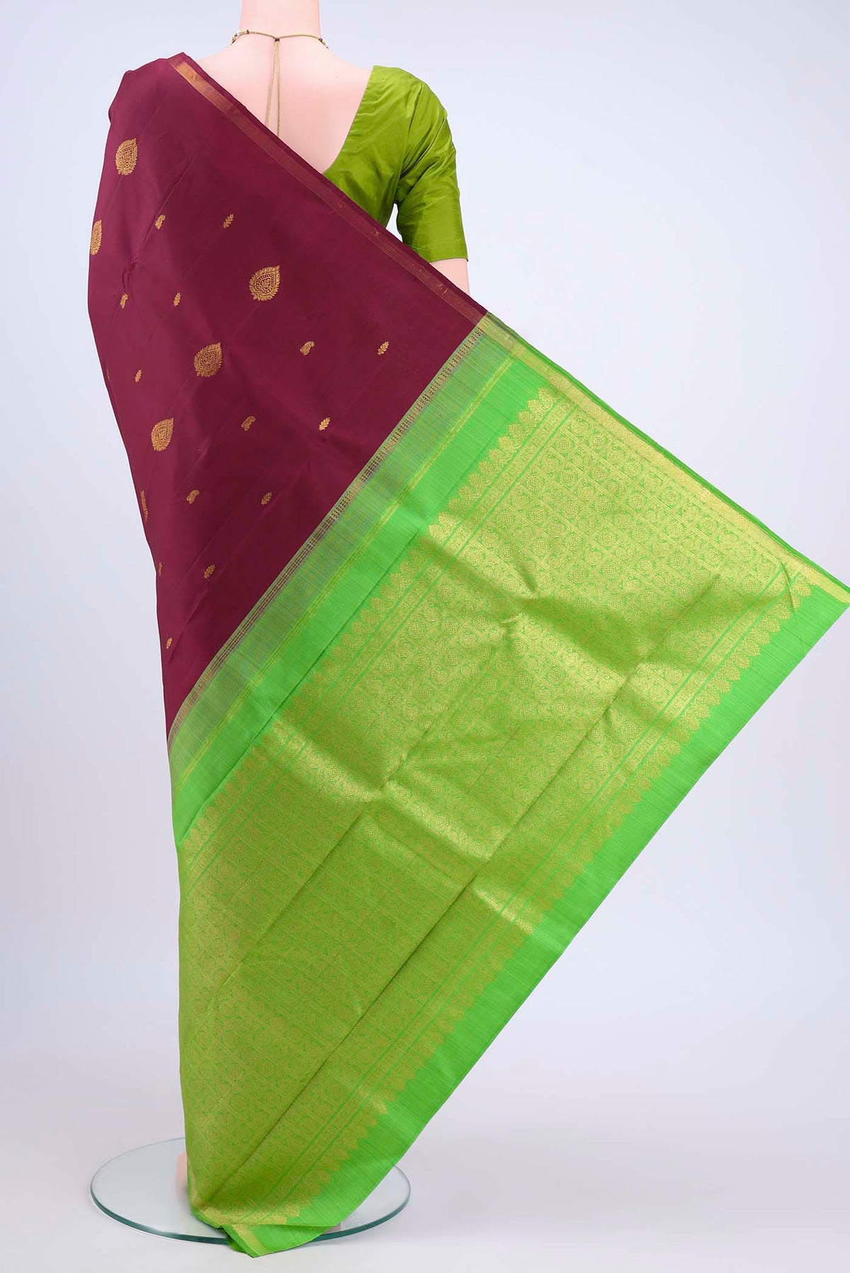Flat view of Maroon Kanchipuram Saree with Zari Butta on the body and Zari Border