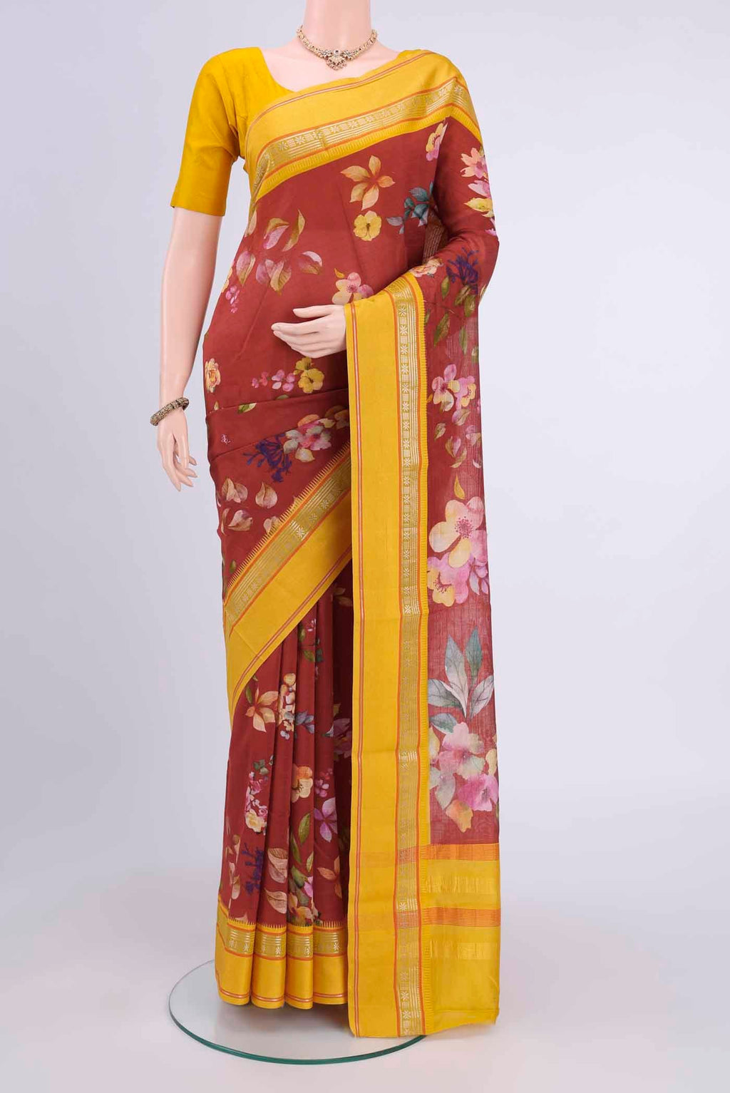 Maroon Chanderi Silk Cotton Saree with Floral Print on the body and Zari Border displayed on a mannequin