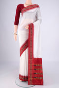 Off White Pochampally Silk Saree with Plain Body and Ikat Border.  displayed on a mannequin