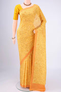 Yellow Printed Silk Saree with Floral Print on the body and Printed Border.  displayed on a mannequin
