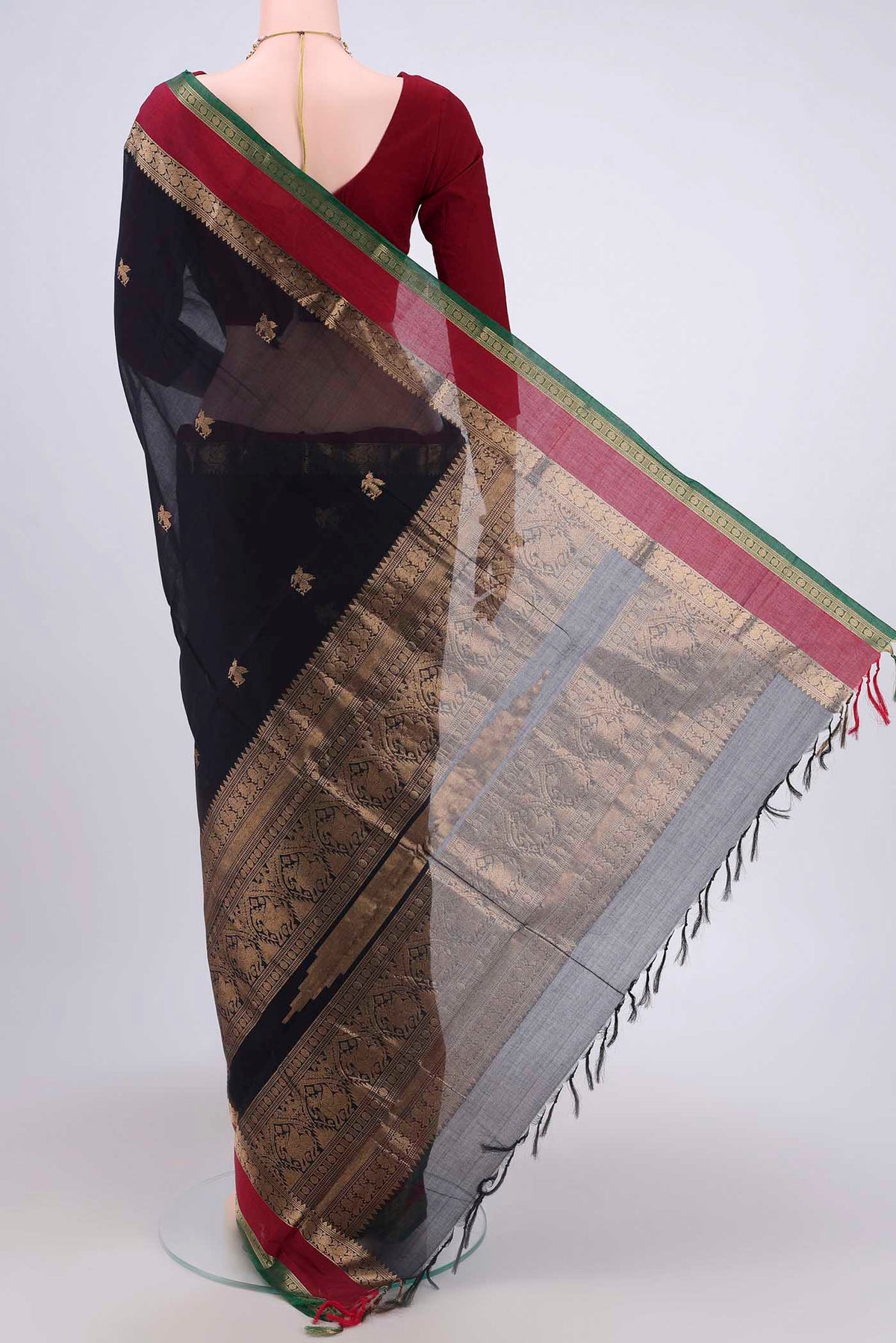 Flat view of Black Kanchi Cotton Saree with Zari Butta on the body and Zari Border. 