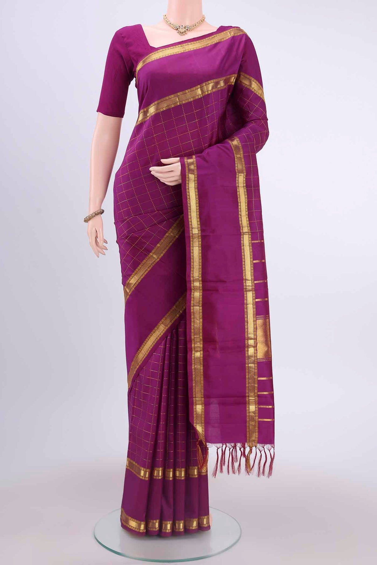 Magenta Kanchipuram Silk Saree with Checked design on the body and Zari Border displayed on a mannequin