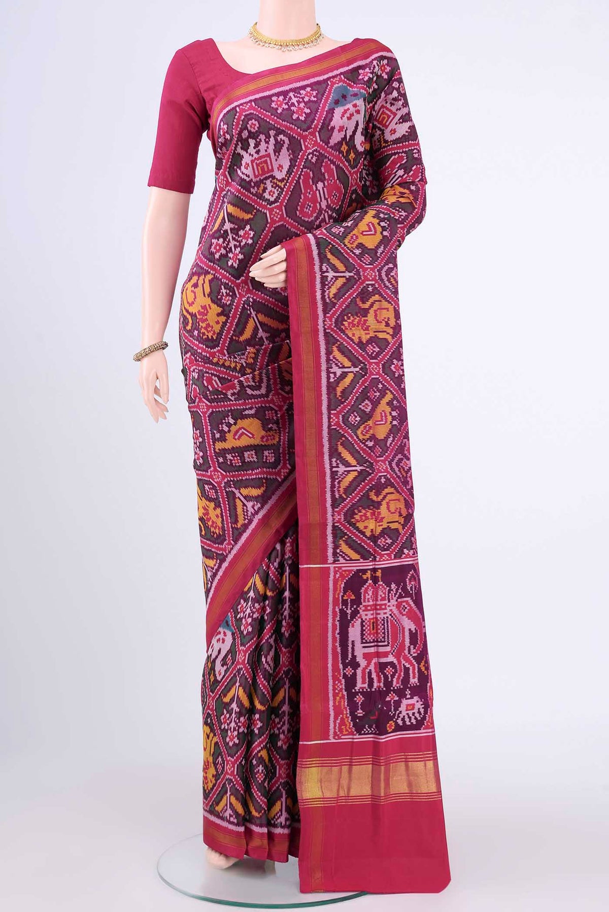 Purple Rajkot Patola Silk Saree with Ikat design on the body and Zari Border displayed on a mannequin