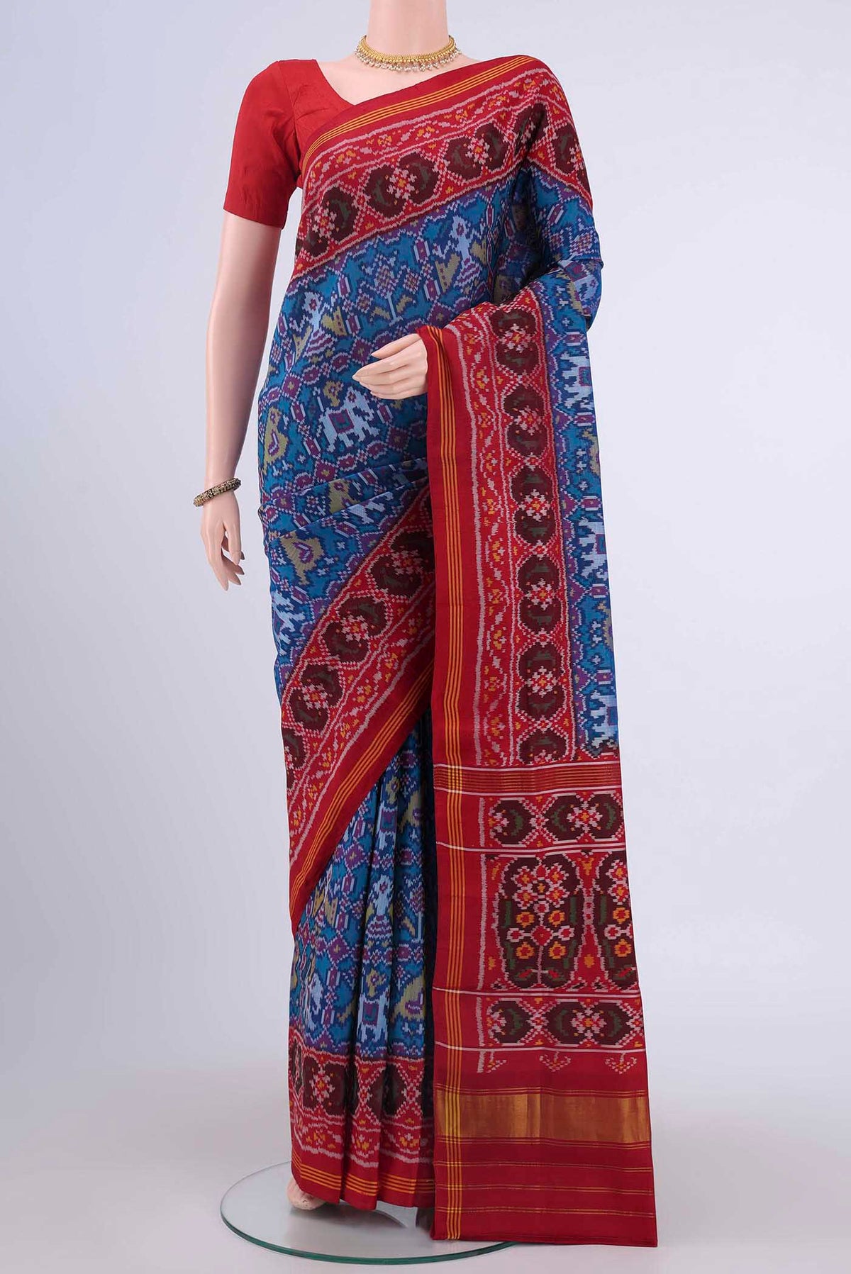 Blue Pochampally Silk Saree with Ikat design on the body and Zari Border displayed on a mannequin