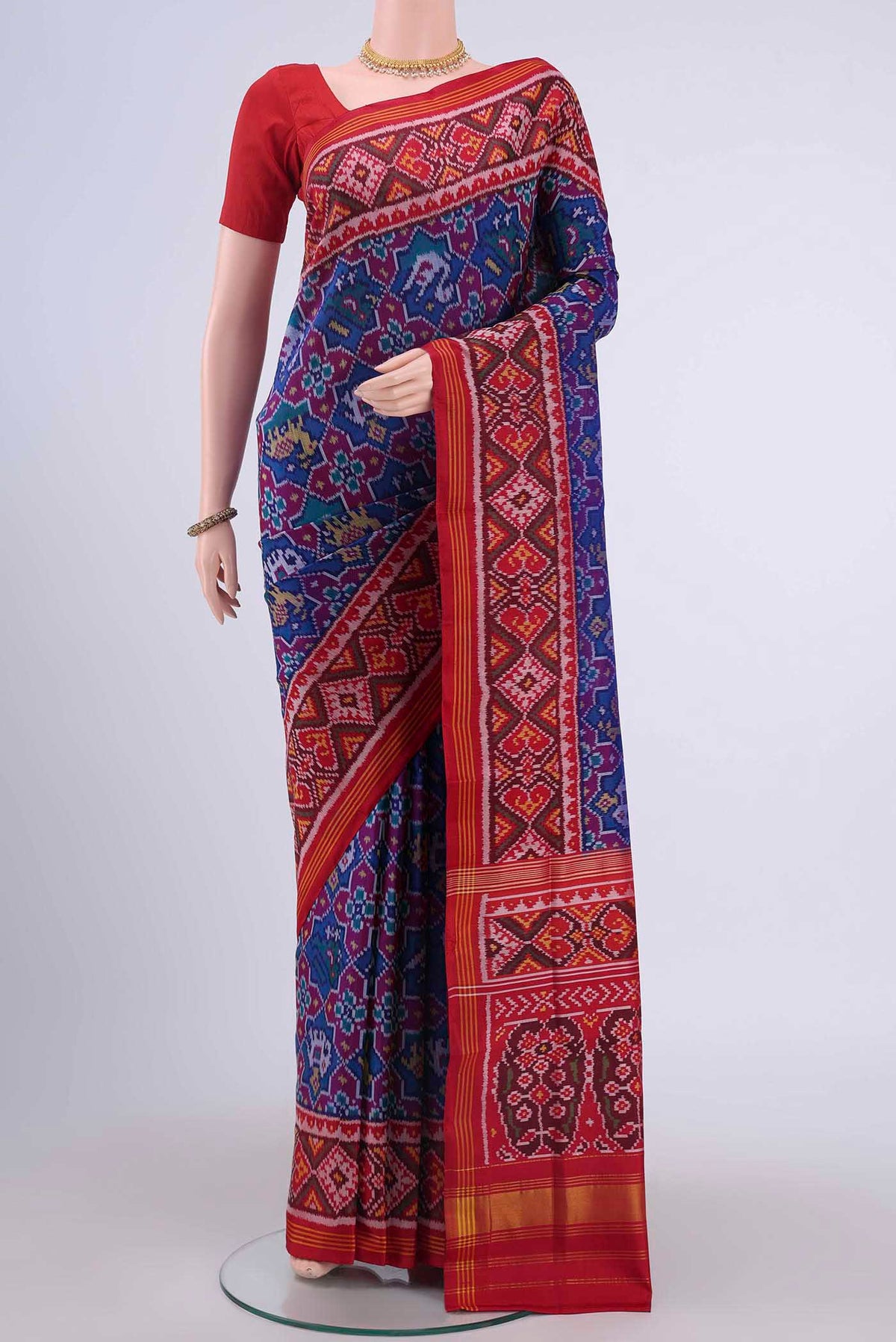 Blue Pochampally Silk Saree with Ikat design on the body and Zari Border displayed on a mannequin