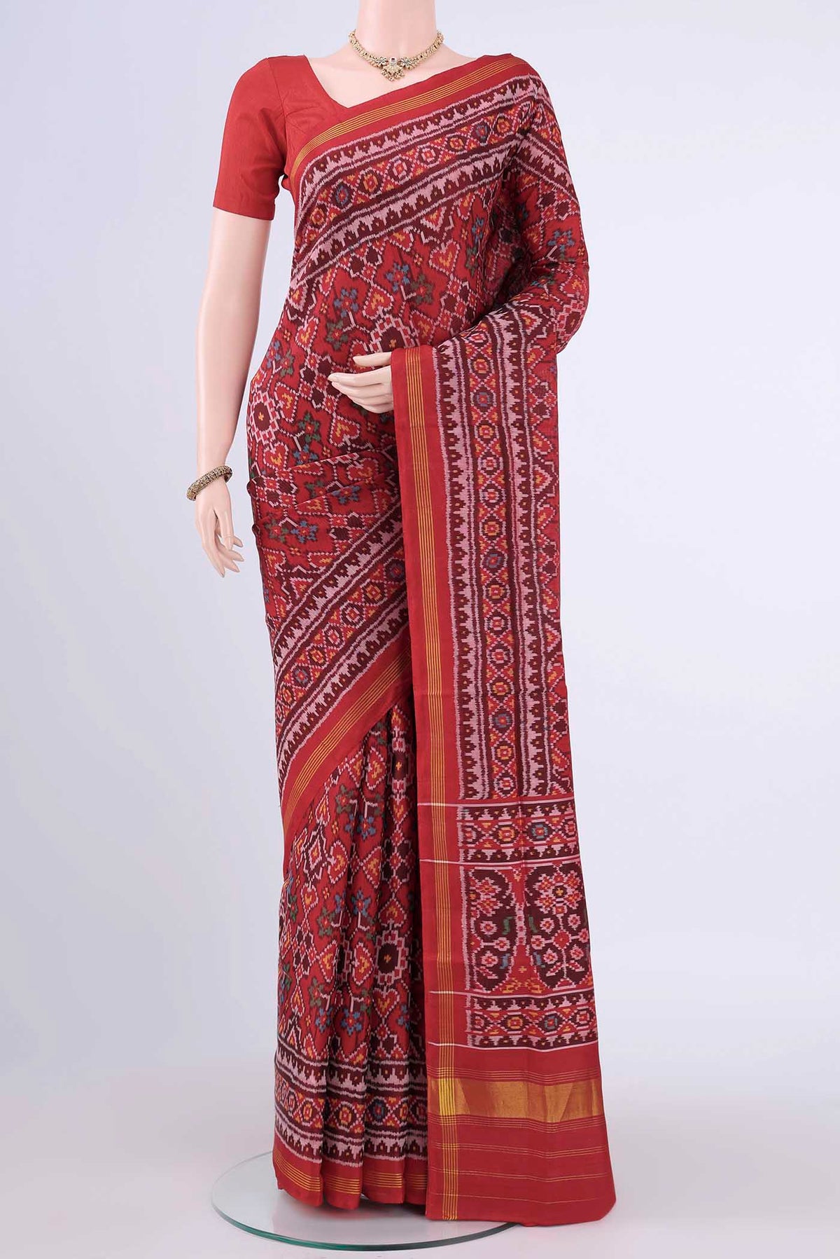 Red Rajkot Patola Silk Saree with Ikat design on the body and Zari Border displayed on a mannequin