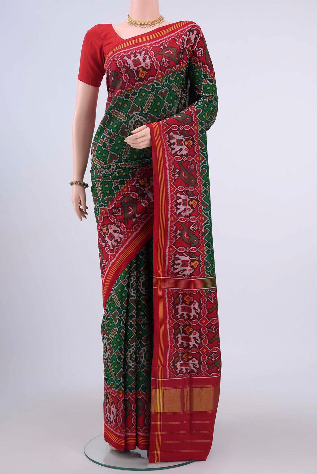 Bottle Green Pochampally Silk Saree with Ikat design on the body and Zari Border displayed on a mannequin