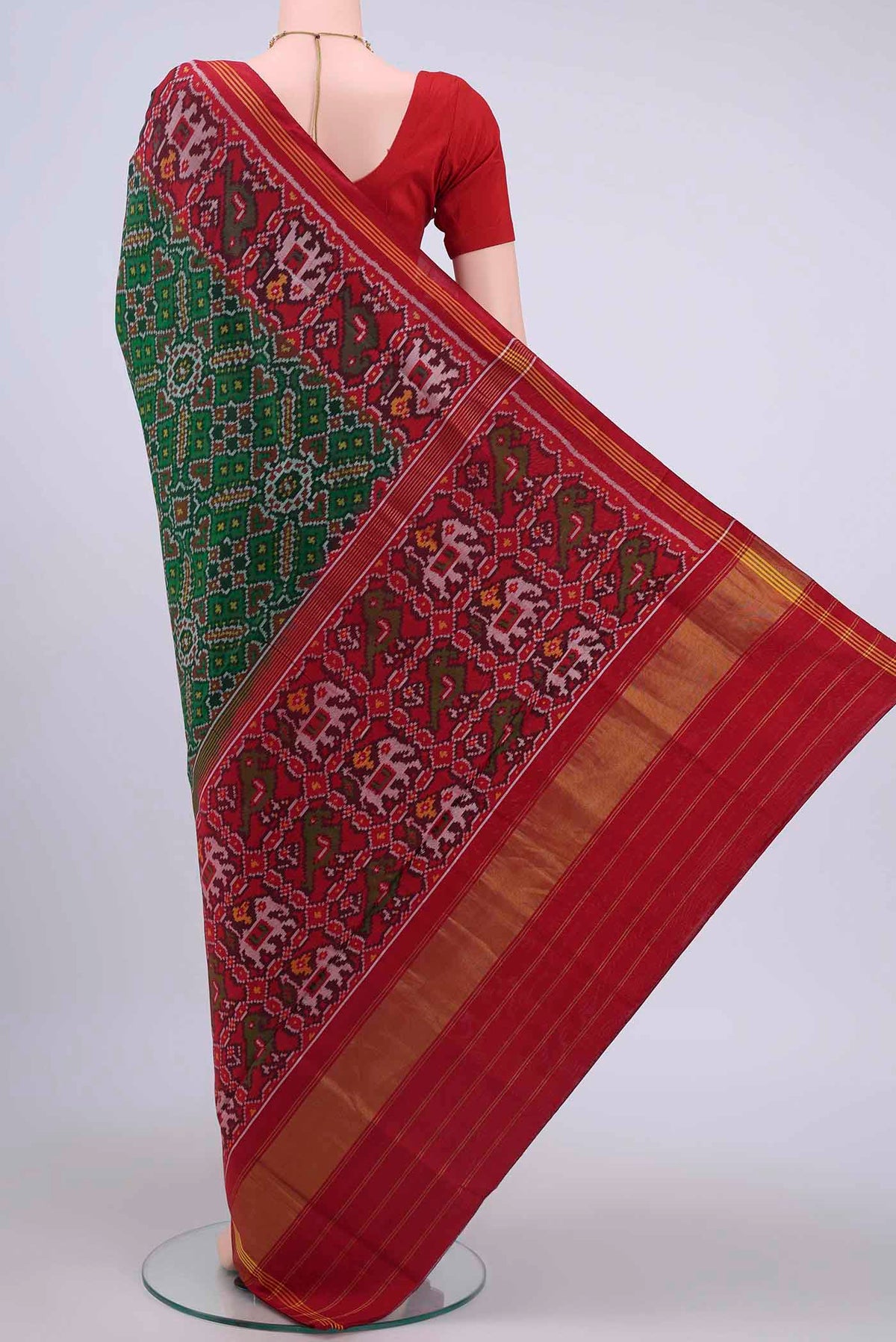 Flat view of Bottle Green Pochampally Silk Saree with Ikat design on the body and Zari Border