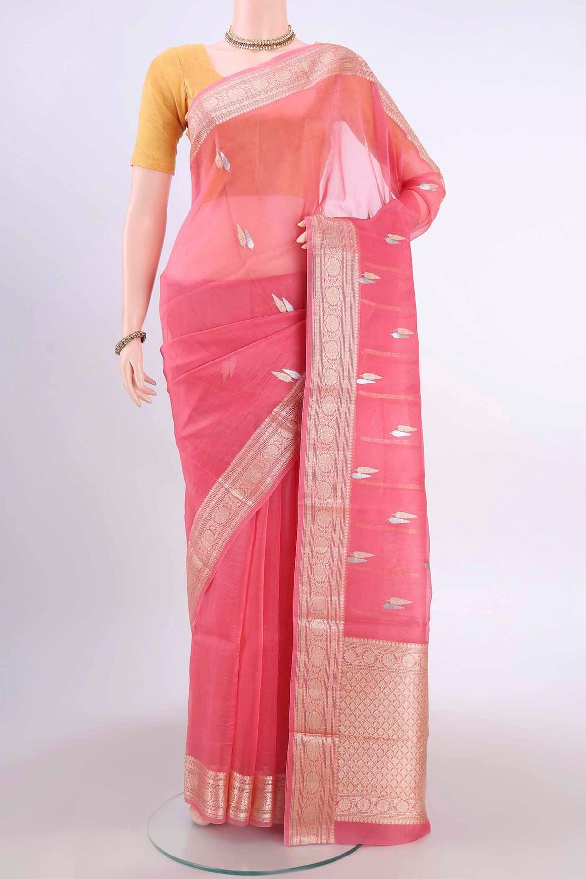 Rose pink Organza Silk Saree with Zari Butta on the body and Zari Border displayed on a mannequin