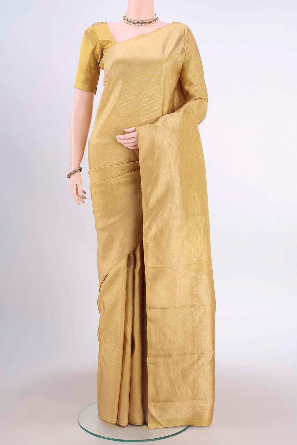 Golden Dual Tone Kanchipuram Saree with Zari Brocade on the body and Zari Border displayed on a mannequin