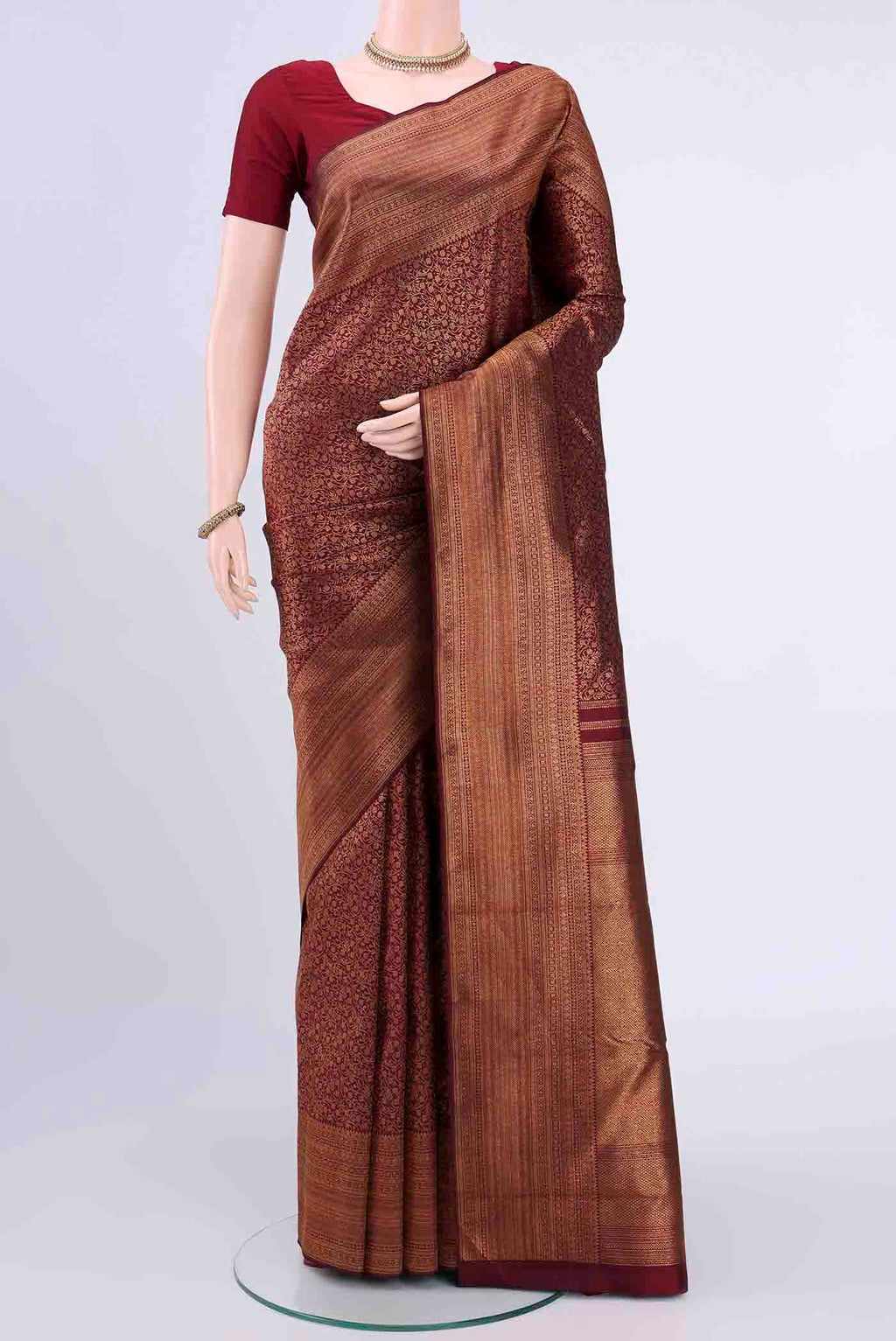 Maroon Kanchipuram Saree with Zari Brocade on the body and Zari Border displayed on a mannequin