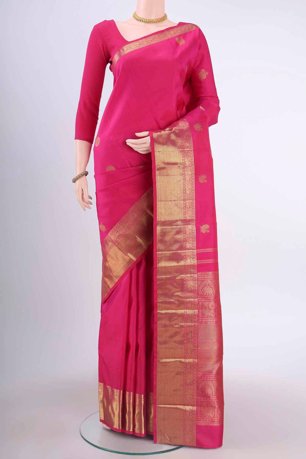 Pure Silk Pure Zari Rani Pink Kanchipuram Saree with Zari Butta on the body and Zari Border displayed on a mannequin