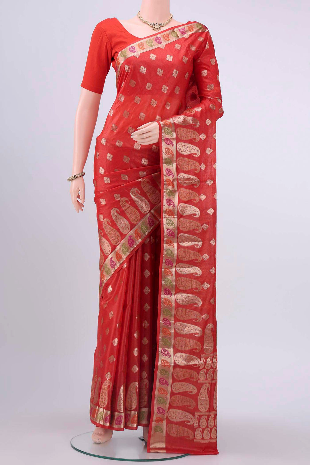 Red Banarasi Tussar Silk Saree with Zari Butta on the body and Zari And Thread Border displayed on a mannequin