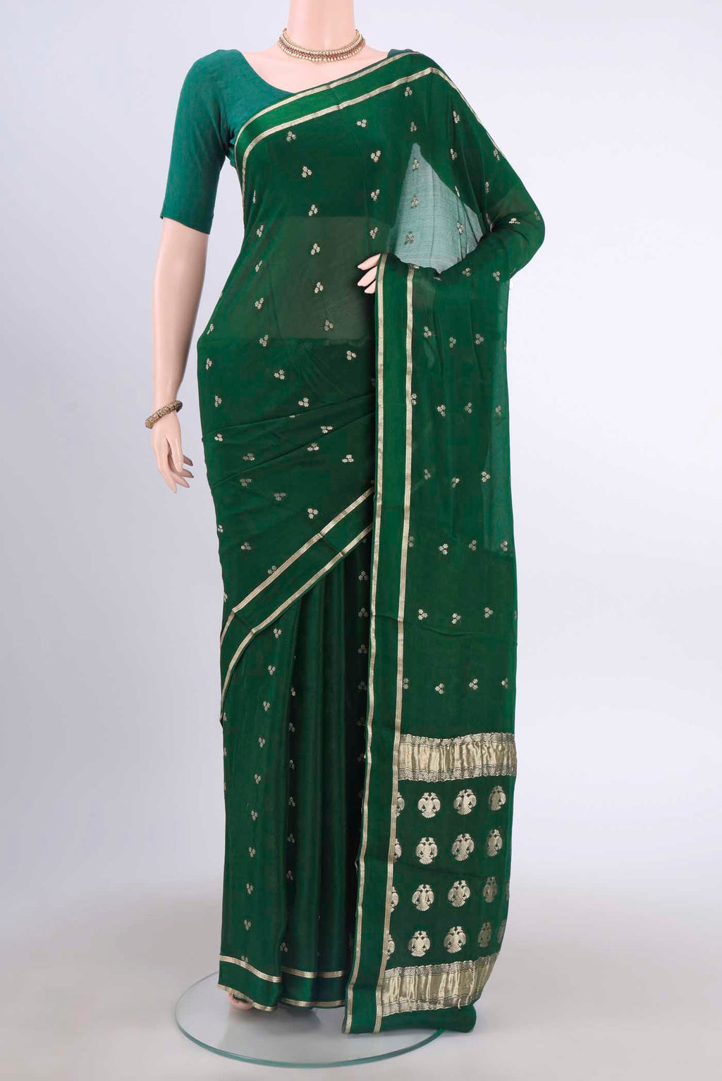 Bottle Green Mysore Crepe Saree with Zari Butta on the body and Satin Border displayed on a mannequin