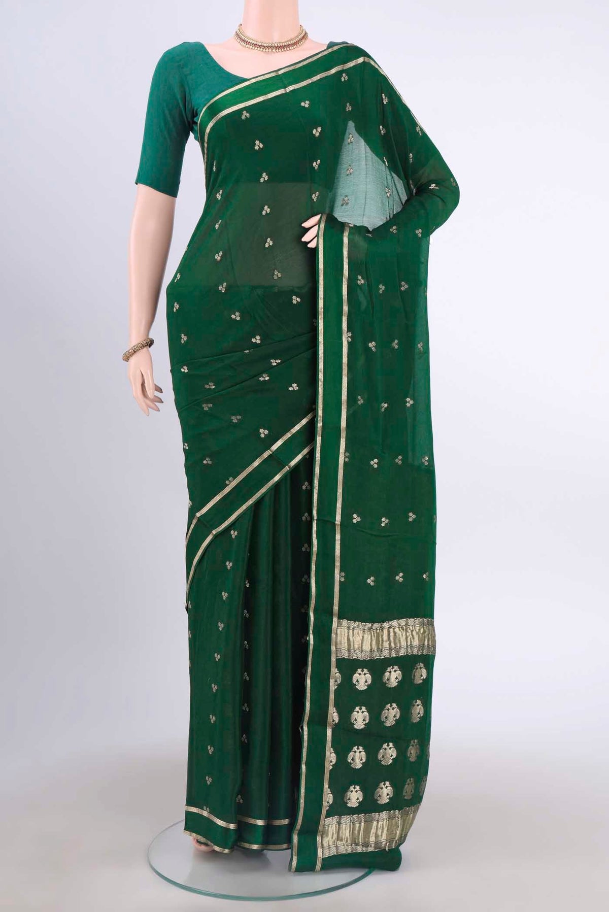 Bottle Green Mysore Crepe Saree with Zari Butta on the body and Satin Border displayed on a mannequin