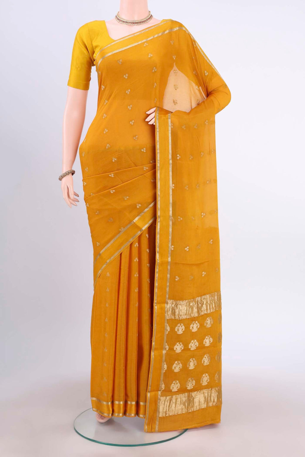 Mustard Mysore Crepe Saree with Zari Butta on the body and Satin Border displayed on a mannequin