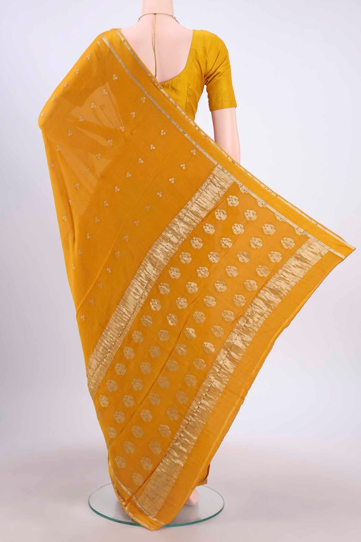 Flat view of Mustard Mysore Crepe Saree with Zari Butta on the body and Satin Border