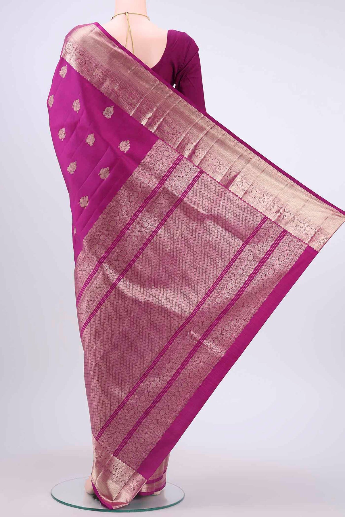 Flat view of Magenta Kanchipuram Silk Saree with Zari Butta on the body and Zari Border