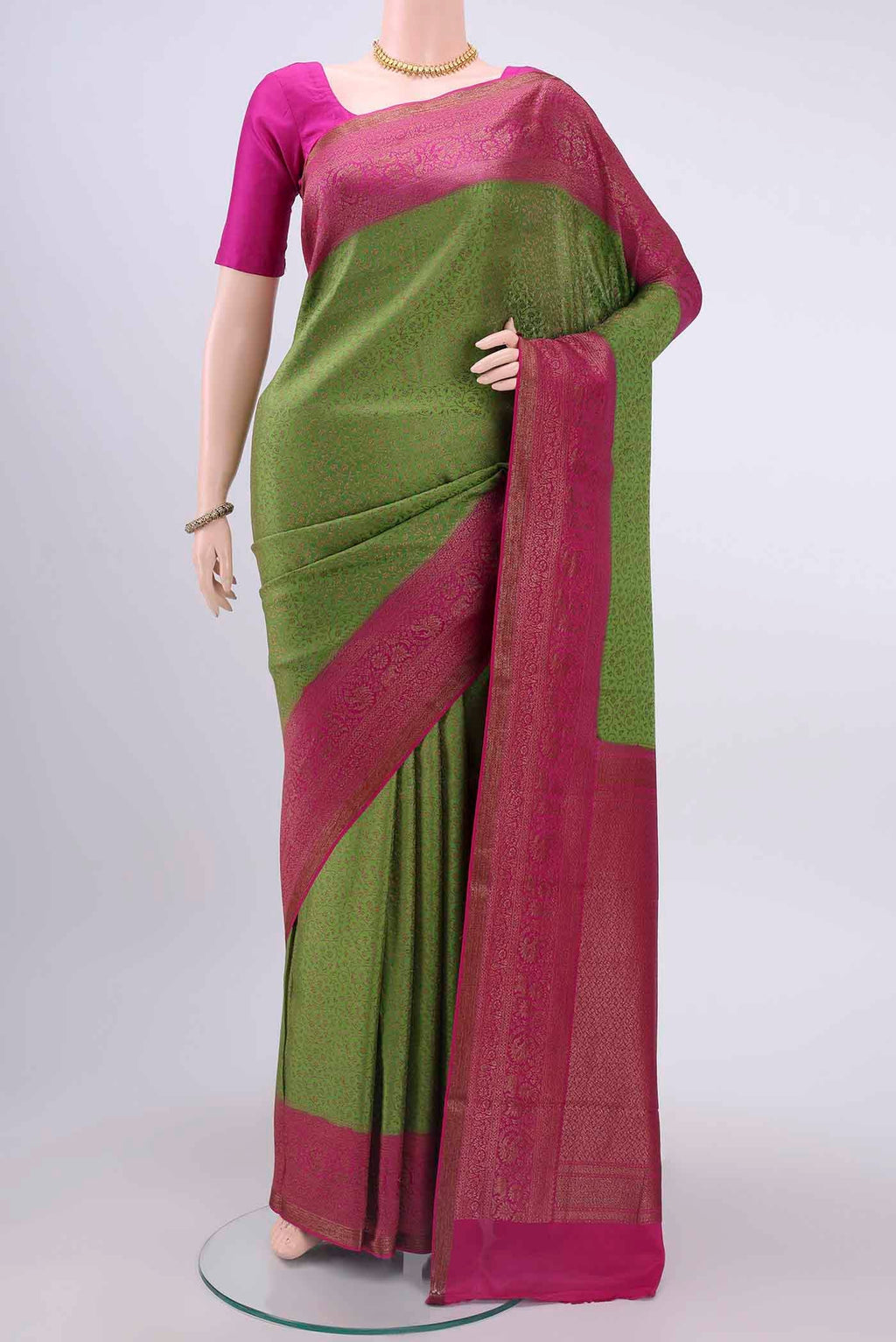 Green Mysore Crepe Saree with Zari Brocade on the body and Zari Border displayed on a mannequin