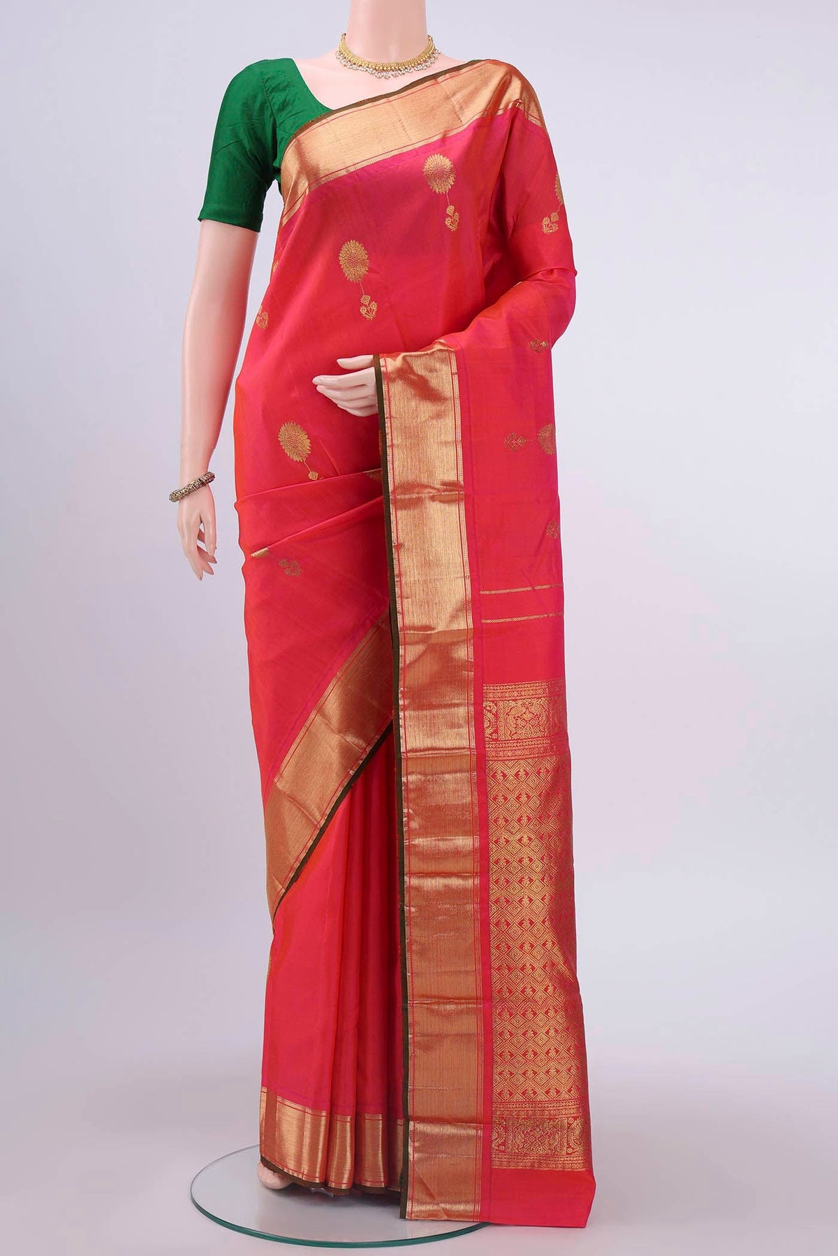 Pink Kanchipuram Silk Saree with Zari Butta on the body and Zari Border displayed on a mannequin