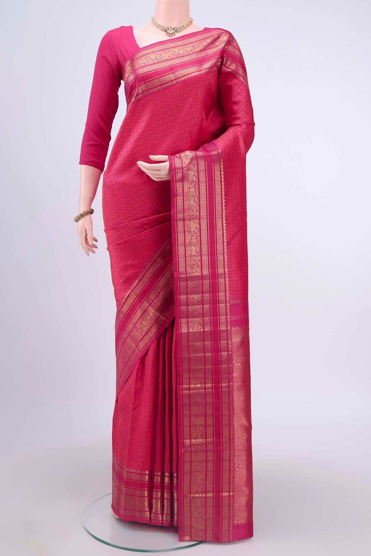 Pure Silk Pure Zari Rani Pink Kanchipuram Saree with Jacquard With Zari Butta on the body and Zari Border displayed on a mannequin