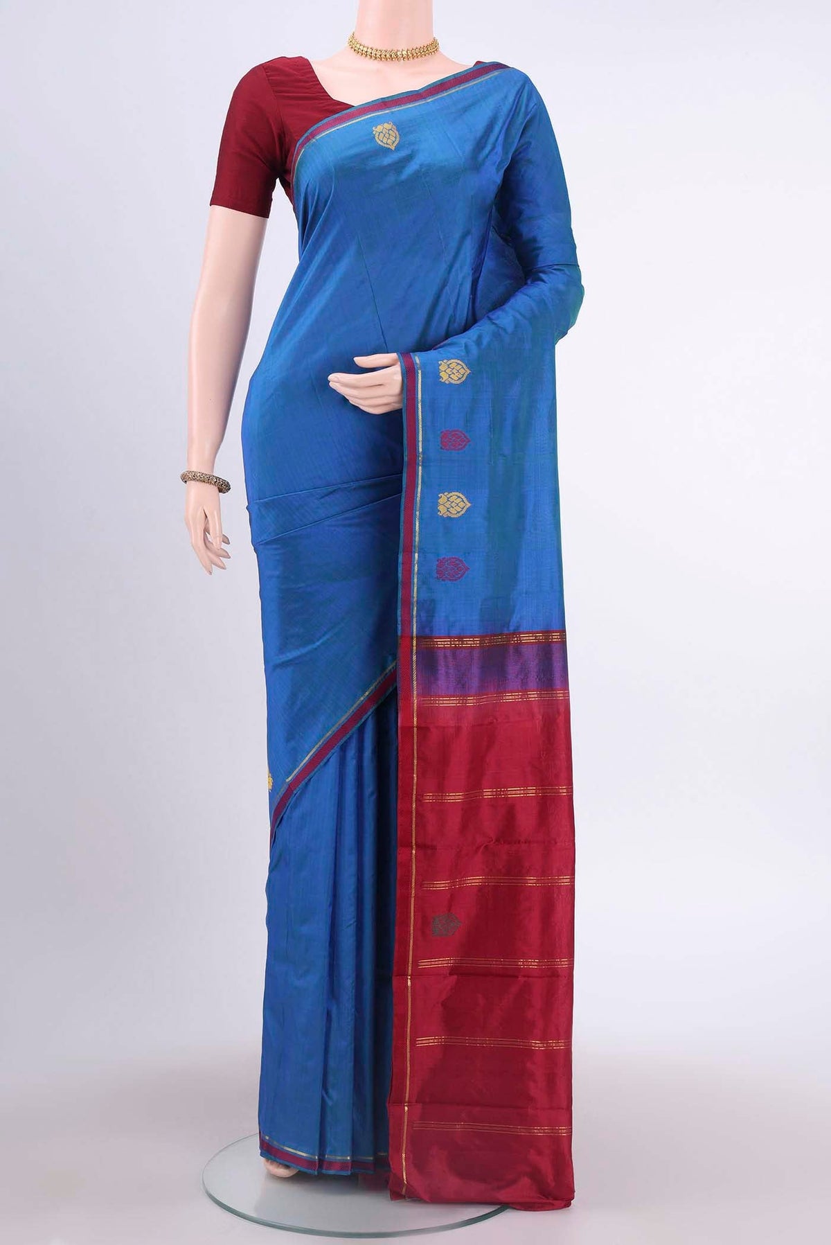 Peacock Blue Dual Tone Kanchipuram Silk Saree with Plain Body and Zari And Thread Border displayed on a mannequin