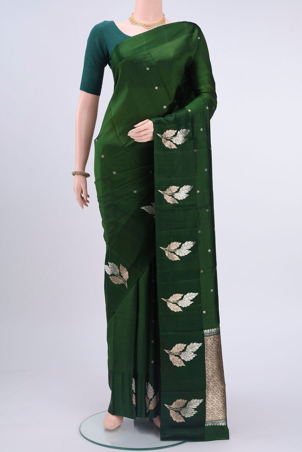 Bottle Green Banarasi Katan Silk Saree with Zari Butta on the body and Zari Border displayed on a mannequin
