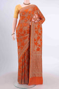 Rust Banarasi Georgette Saree with Zari Brocade on the body and Zari Border displayed on a mannequin