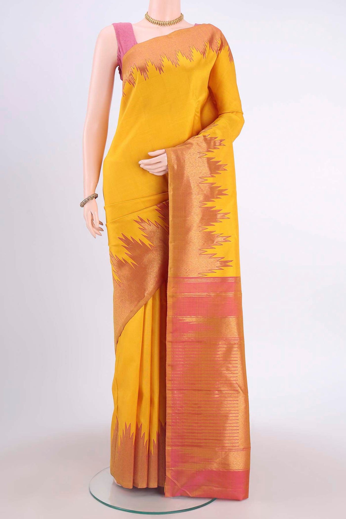 Yellow Kanchipuram Saree with Plain Body and Temple Border displayed on a mannequin