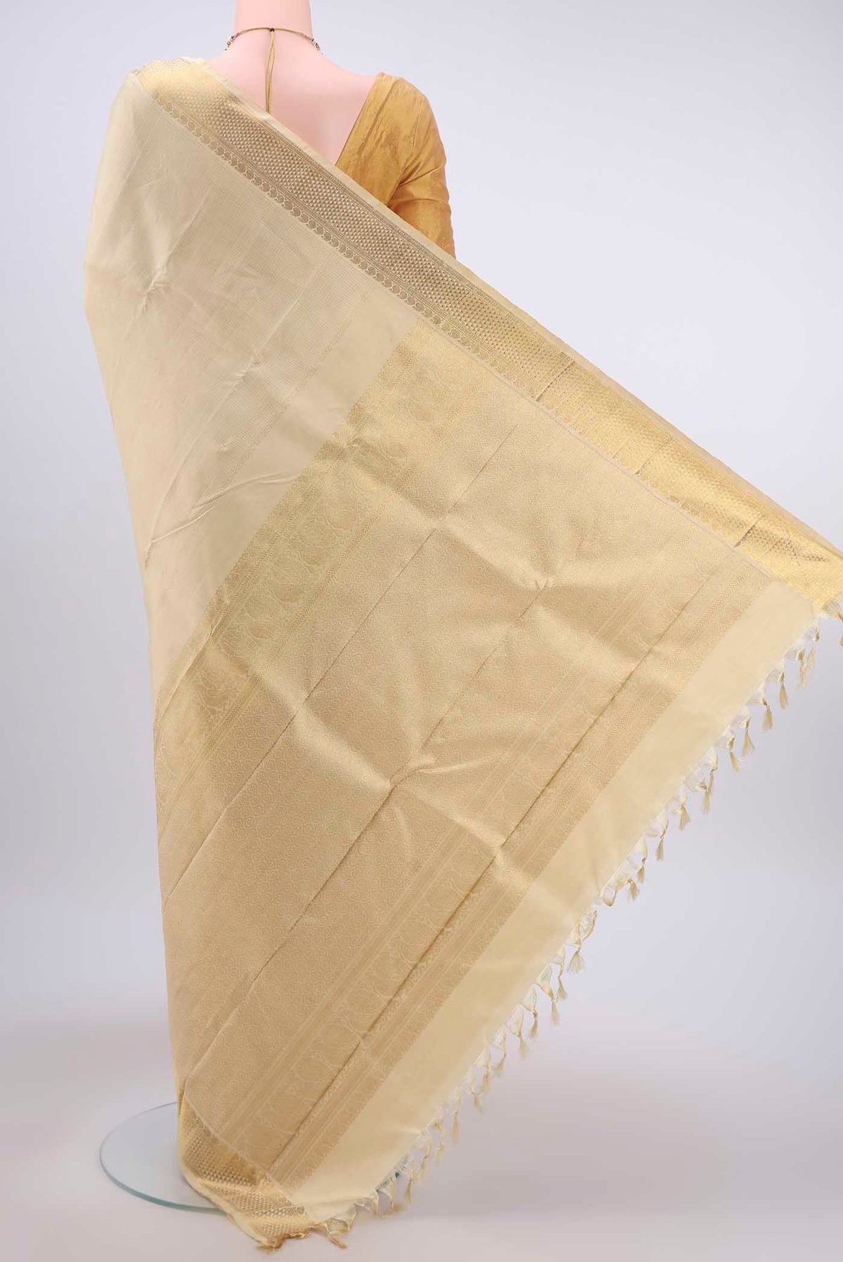 Flat view of Cream Kanchipuram Silk Saree with Zari Brocade on the body and Zari Border