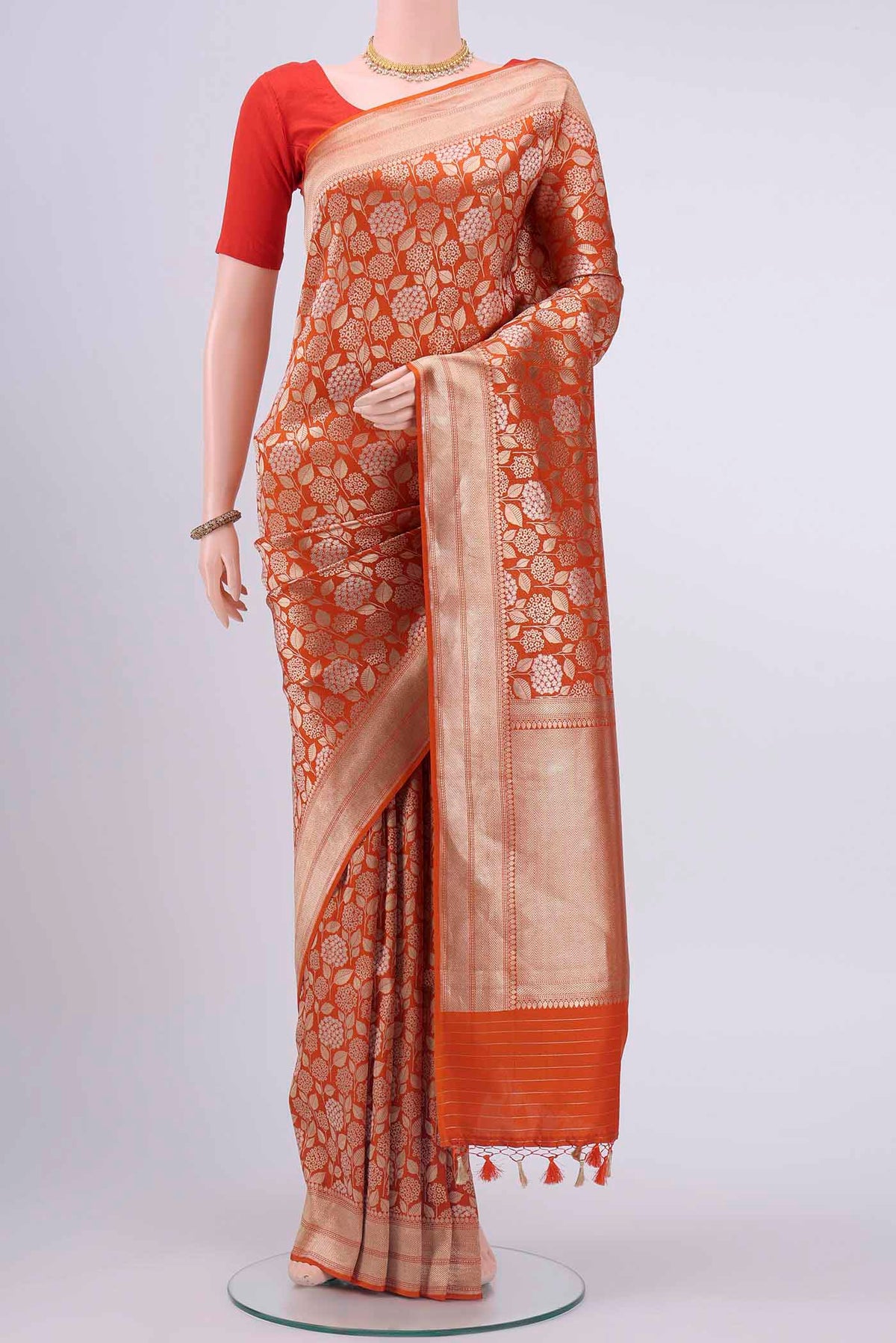 Brick Orange Dual Tone Banarasi Silk Saree with Zari Brocade on the body and Zari Border displayed on a mannequin