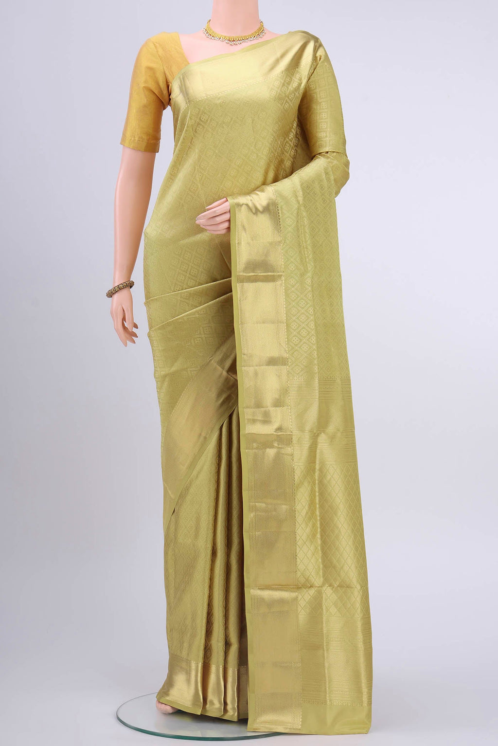 Golden Soft Silk Saree with Zari Brocade on the body and Zari Border displayed on a mannequin