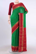 Green Mysore Crepe Saree with Plain Body and Zari Border displayed on a mannequin