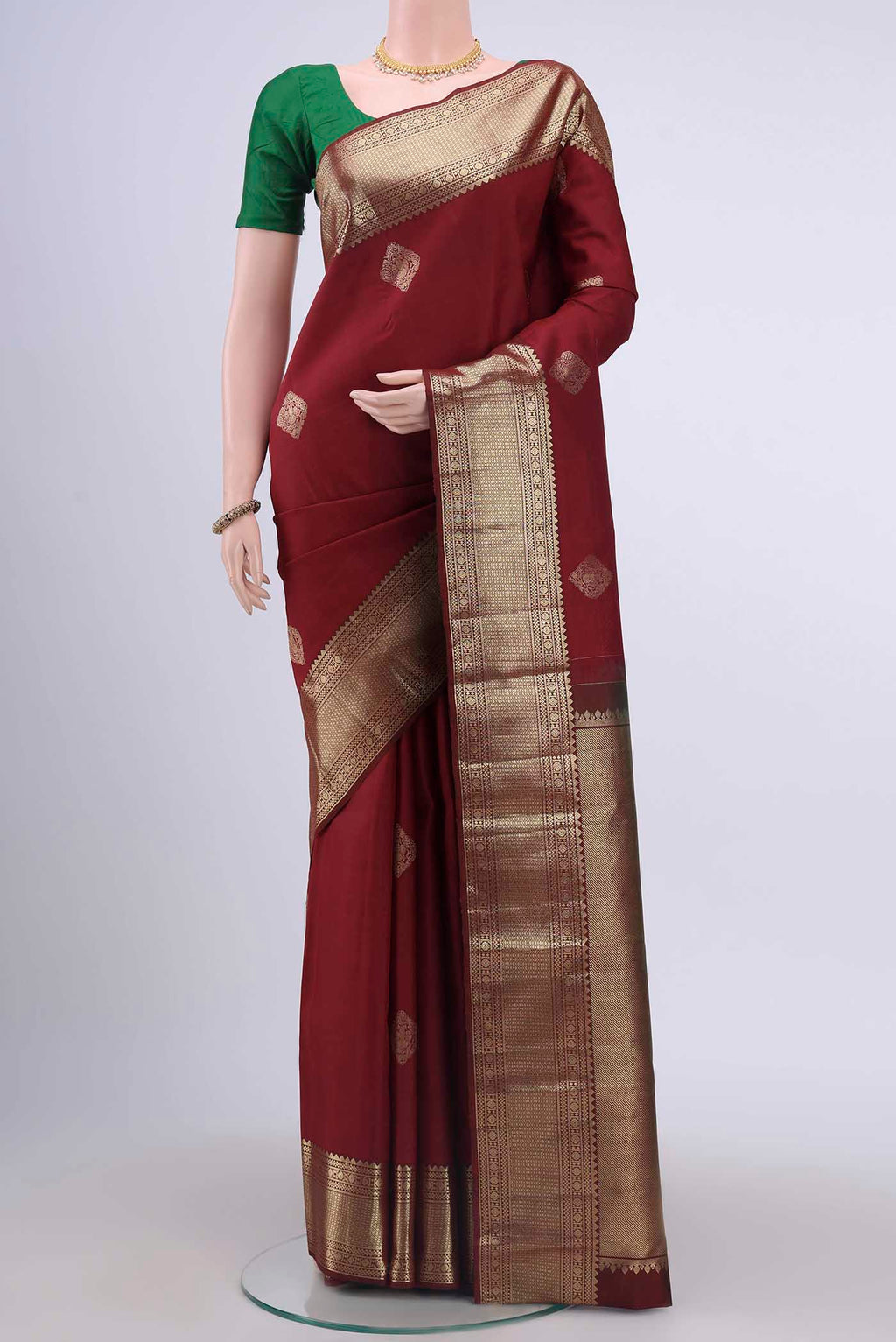 Maroon Kanchipuram Saree with Zari Butta on the body and Zari Border displayed on a mannequin