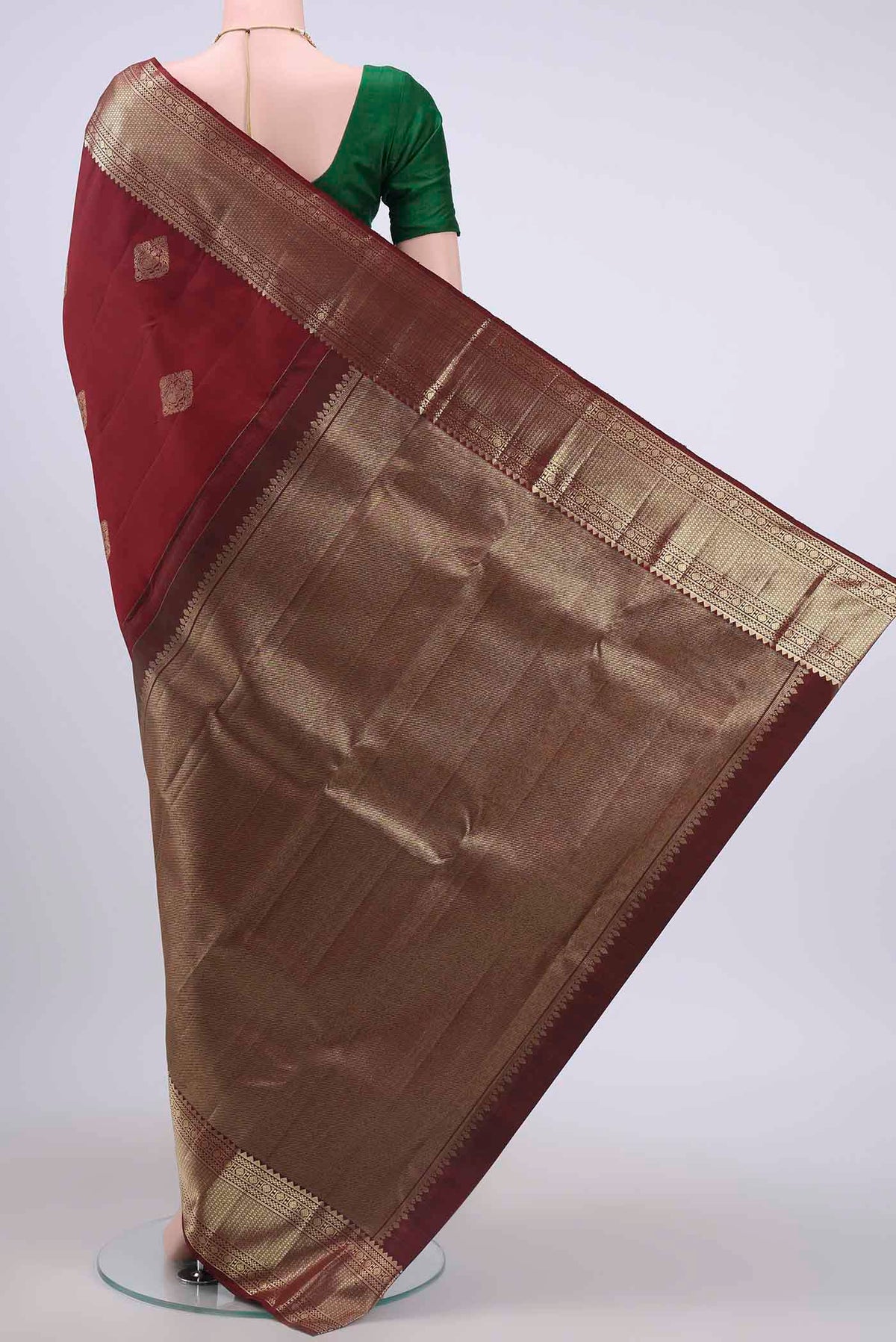 Flat view of Maroon Kanchipuram Saree with Zari Butta on the body and Zari Border