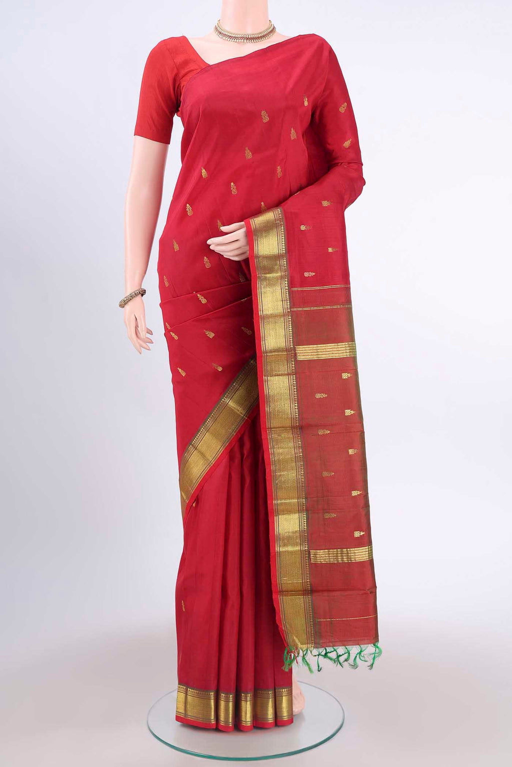 Red Kanchipuram Silk Saree with Zari Butta on the body and One Side Border displayed on a mannequin