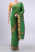 Green Kanchipuram Silk Saree with Zari Butta on the body and One Side Border displayed on a mannequin