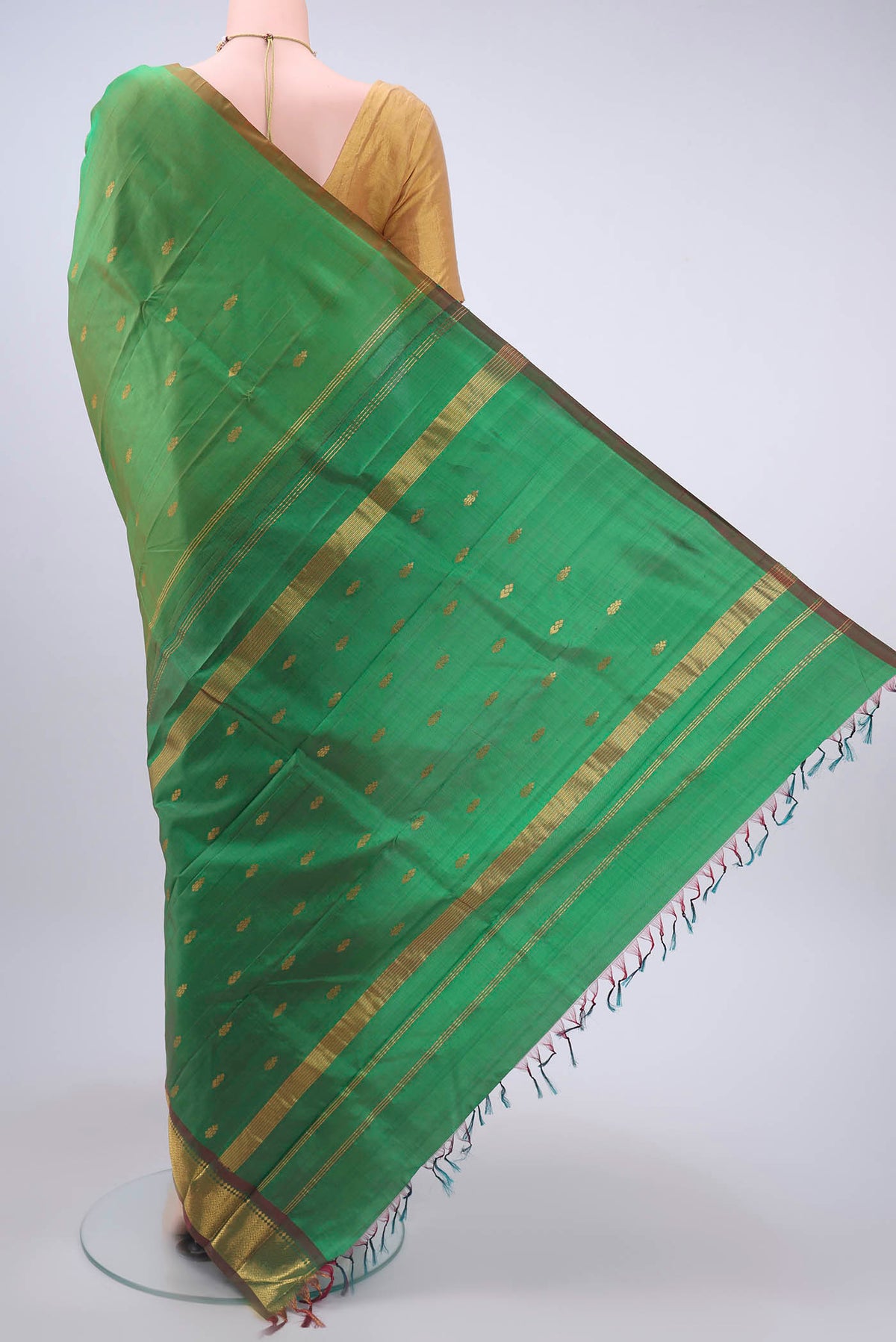 Flat view of Green Kanchipuram Silk Saree with Zari Butta on the body and One Side Border