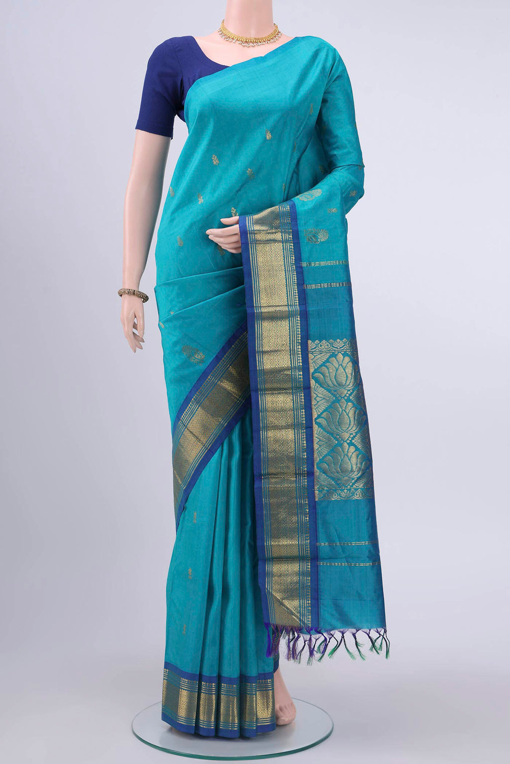 Turquoise Kanchipuram Silk Saree with Zari Butta on the body and One Side Border displayed on a mannequin