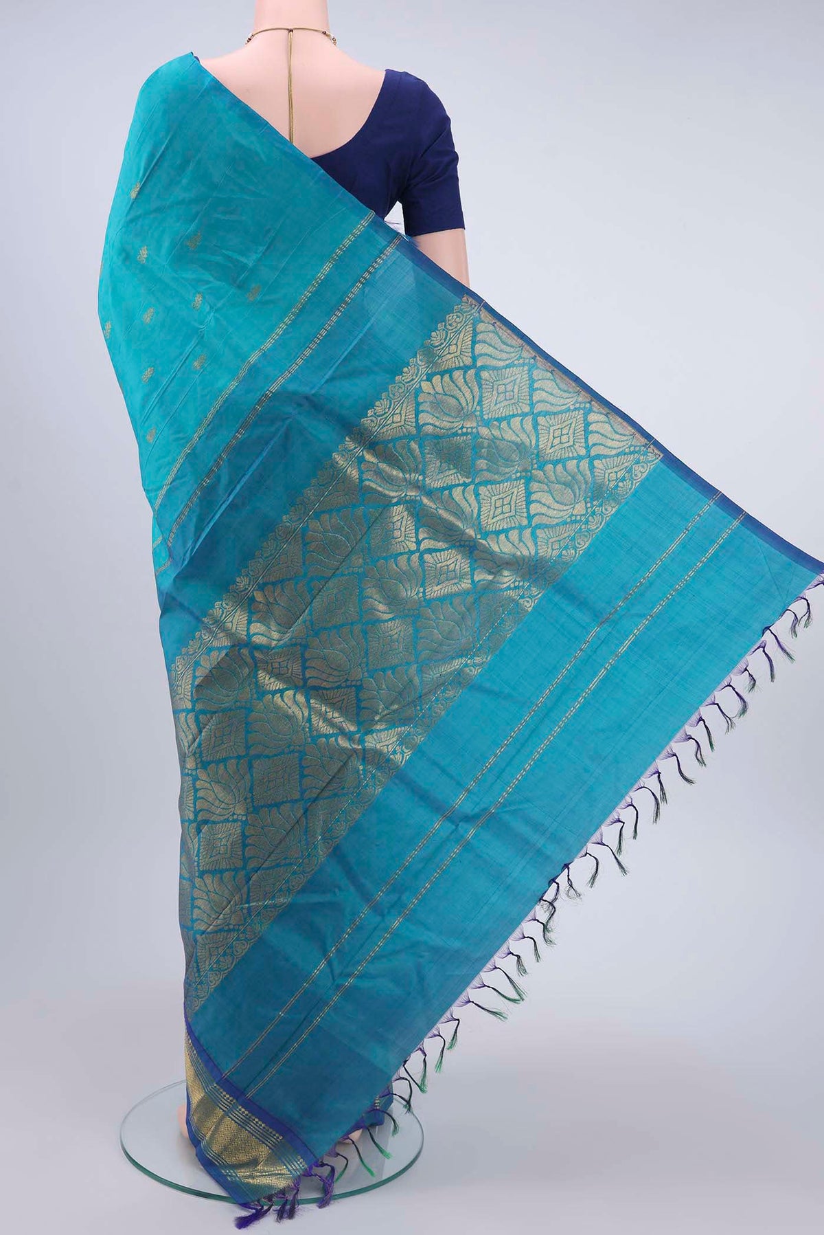 Flat view of Turquoise Kanchipuram Silk Saree with Zari Butta on the body and One Side Border