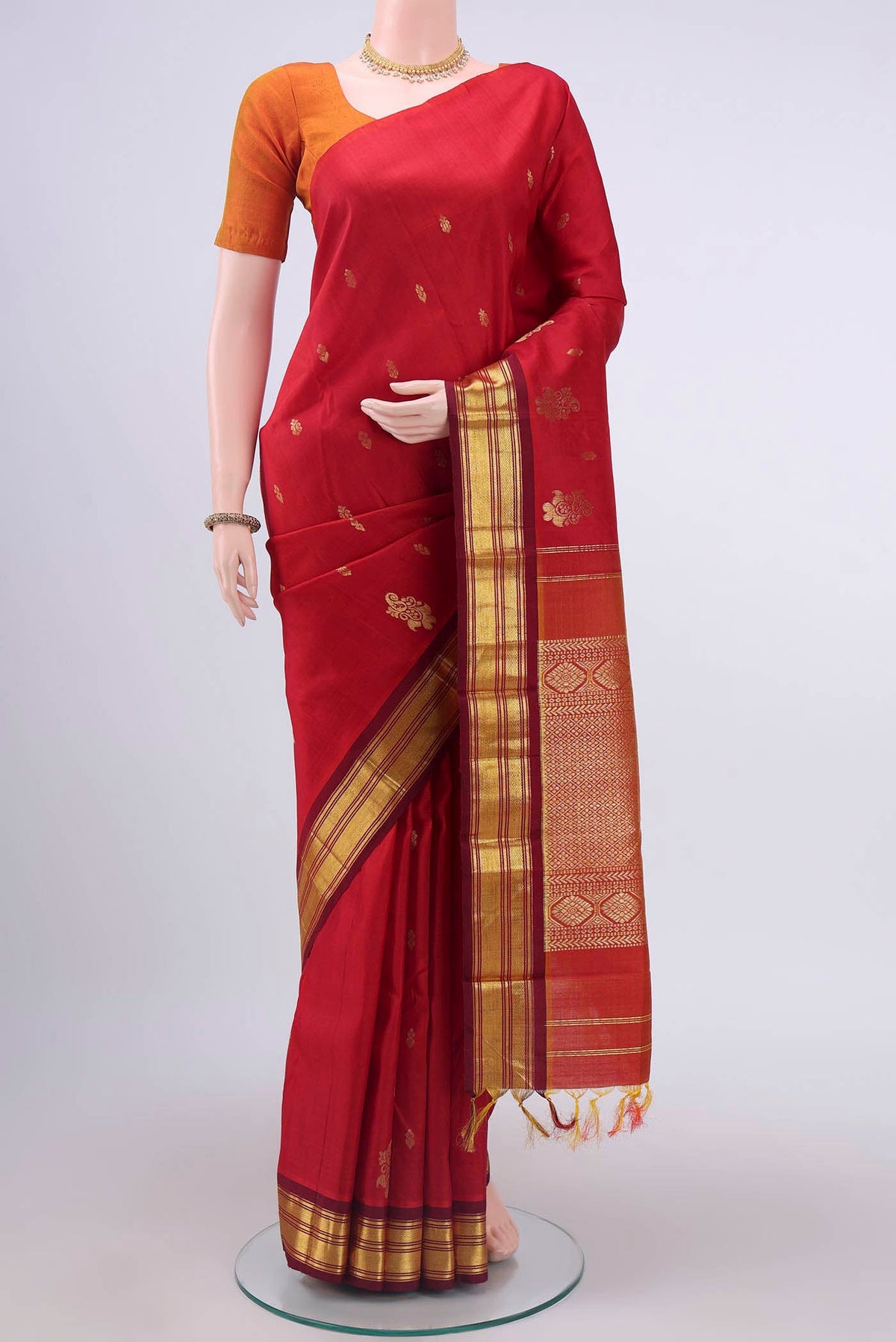 Red Kanchipuram Silk Saree with Zari Butta on the body and One Side Border displayed on a mannequin