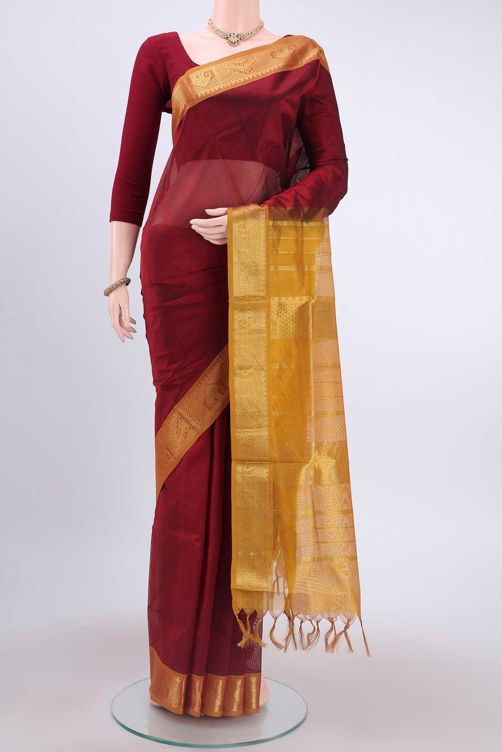 Maroon Coimbatore Silk Cotton Saree with Plain Body and Zari Border displayed on a mannequin