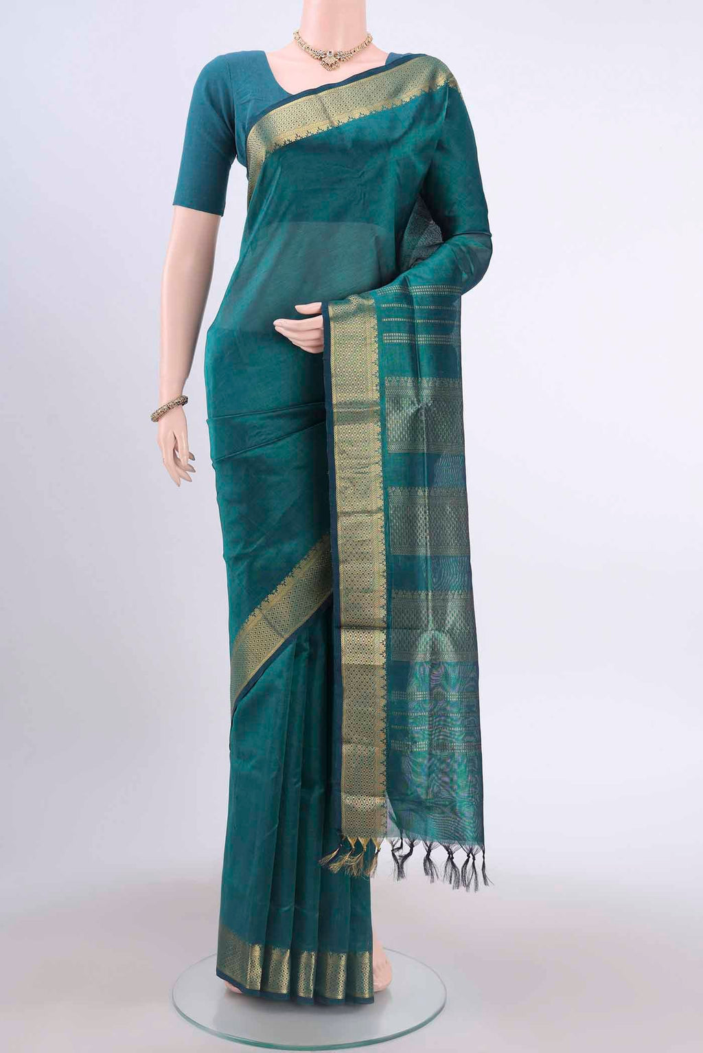 Sea Green Silk Cotton Saree with Plain Body and Zari Border displayed on a mannequin