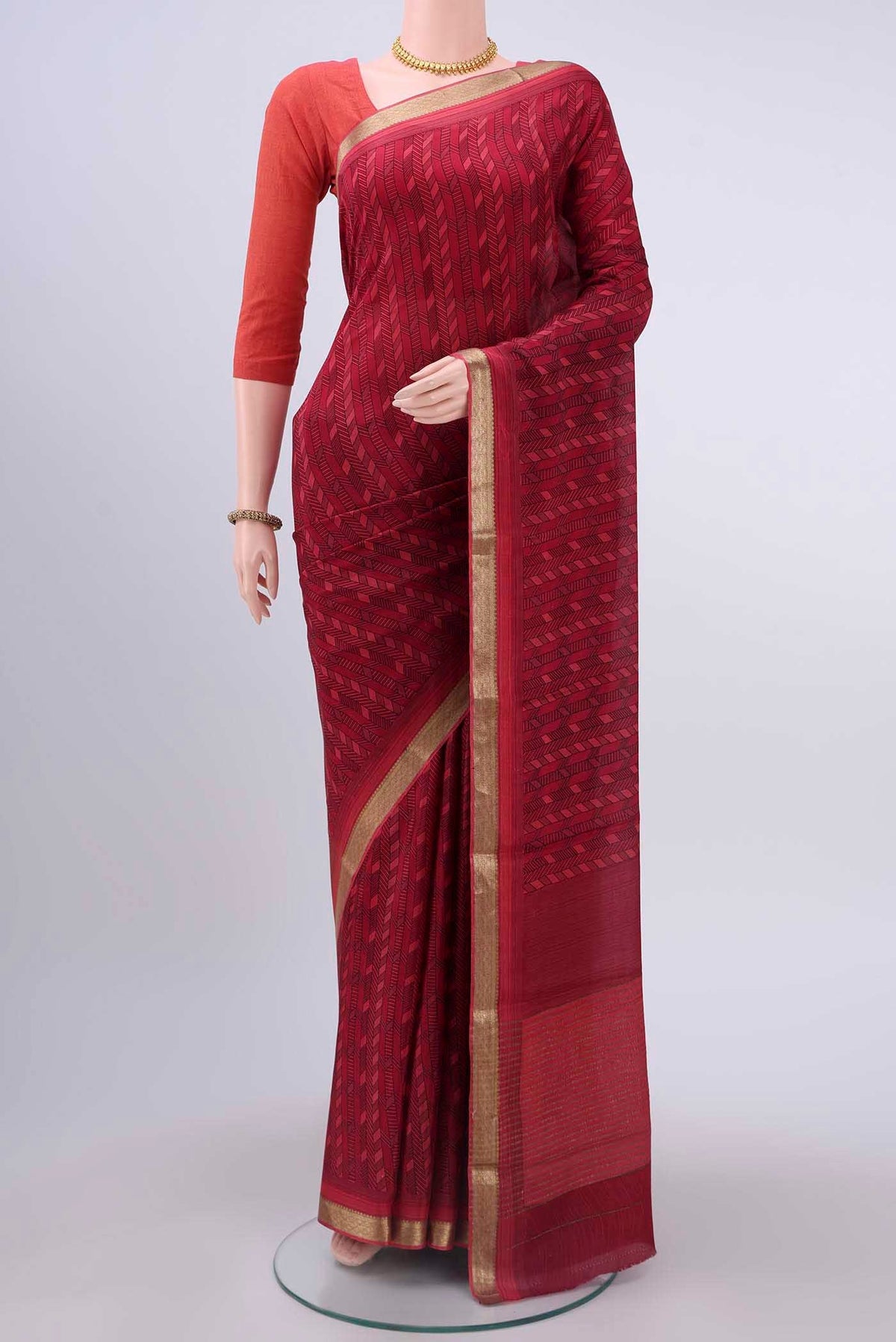 Maroon Mysore Crepe Saree with Floral Print on the body and Zari Border displayed on a mannequin