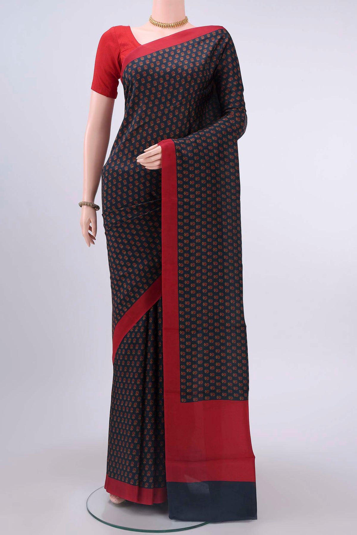 Navy Blue Printed Silk Saree with Printed design on the body and Lace Border displayed on a mannequin