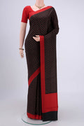 Black Printed Silk Saree with Printed design on the body and Plain Border.  displayed on a mannequin